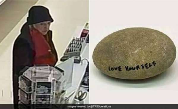 Woman Walks Out Of Museum Holding A Rock